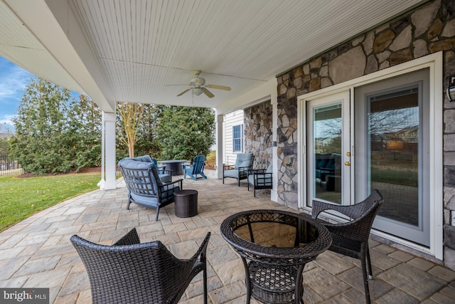 view of patio with an outdoor living space and ceiling fan