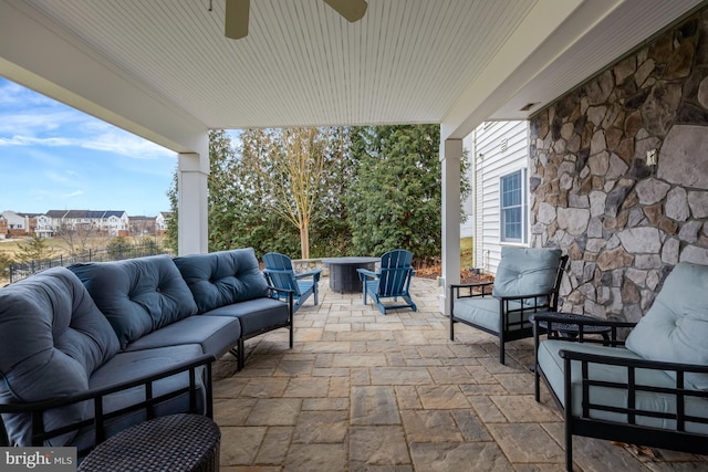 view of patio / terrace with an outdoor living space with a fire pit and a ceiling fan