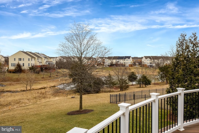 view of yard featuring a residential view and fence