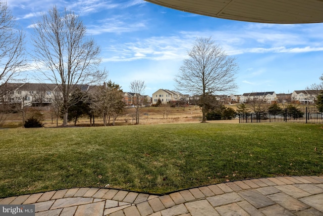 view of yard featuring a residential view and fence