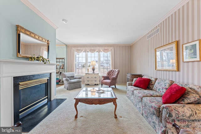 carpeted living room featuring wallpapered walls, ornamental molding, and a high end fireplace