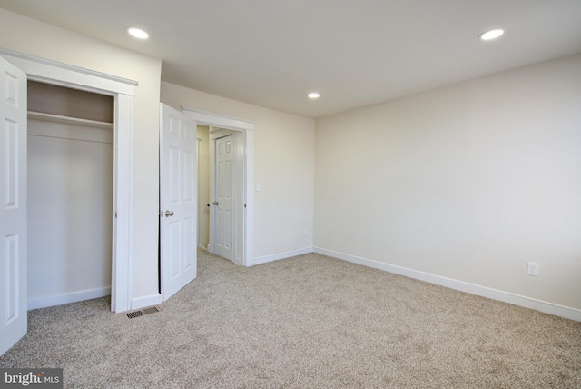 unfurnished bedroom featuring carpet floors, recessed lighting, visible vents, and baseboards