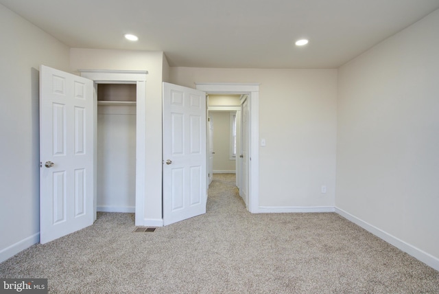 unfurnished bedroom featuring recessed lighting, a closet, carpet flooring, and baseboards