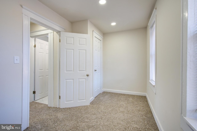 interior space with carpet, baseboards, and recessed lighting