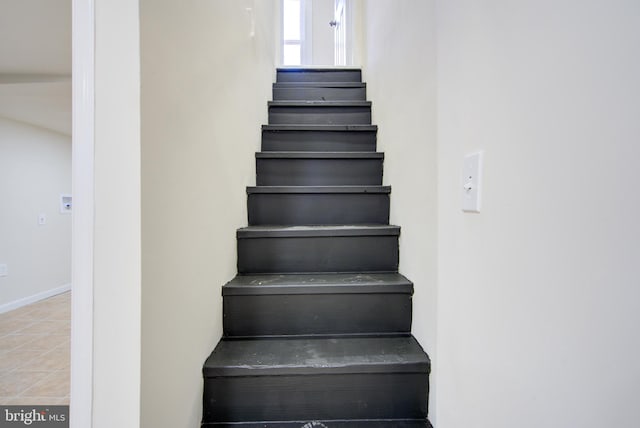 staircase with tile patterned flooring