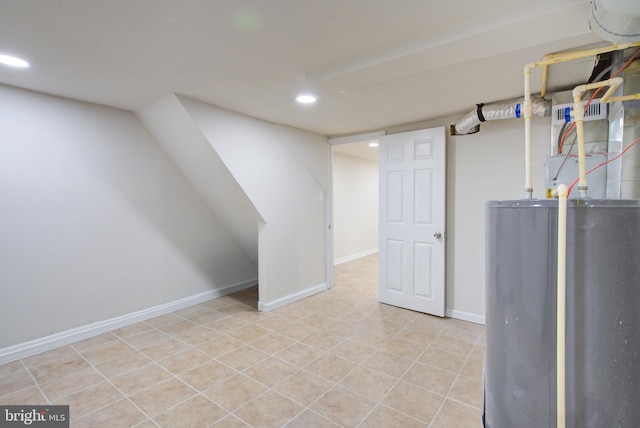 finished basement with water heater, recessed lighting, tile patterned flooring, and baseboards