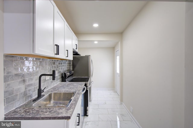 kitchen featuring electric range, baseboards, dark countertops, marble finish floor, and a sink