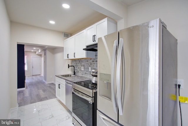 kitchen featuring marble finish floor, visible vents, appliances with stainless steel finishes, a sink, and under cabinet range hood