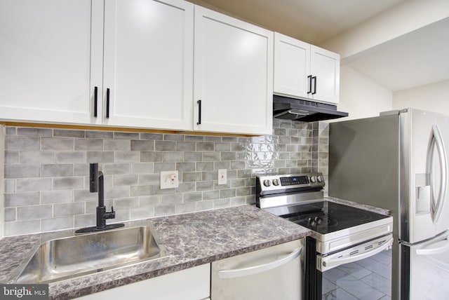 kitchen featuring backsplash, appliances with stainless steel finishes, white cabinetry, a sink, and under cabinet range hood