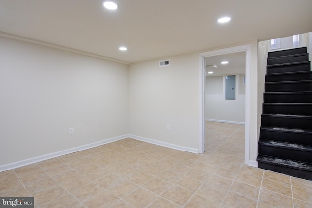 finished basement featuring baseboards, visible vents, stairway, and recessed lighting