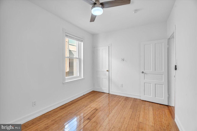 unfurnished bedroom with baseboards, ceiling fan, and light wood finished floors