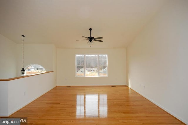 unfurnished room featuring ceiling fan, lofted ceiling, and light wood-style flooring