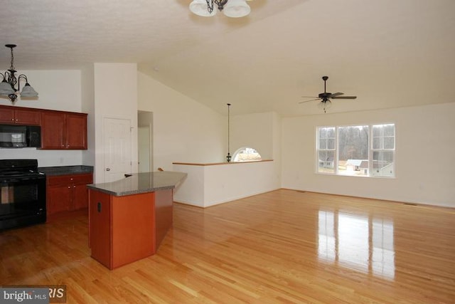 kitchen featuring light wood-style flooring, ceiling fan with notable chandelier, a center island, black appliances, and decorative light fixtures
