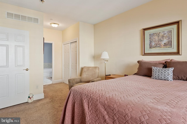 bedroom with a closet, visible vents, carpet flooring, connected bathroom, and baseboards