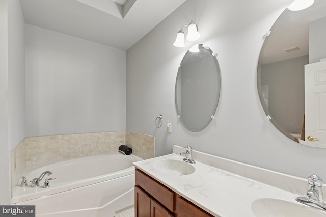 bathroom featuring a bath, double vanity, and a sink