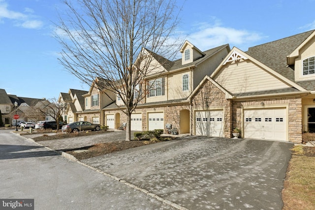 townhome / multi-family property with driveway, a garage, and a residential view