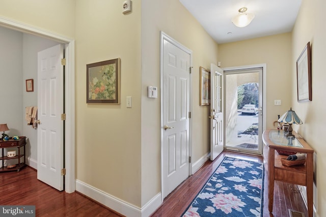 entrance foyer featuring dark wood-style floors and baseboards