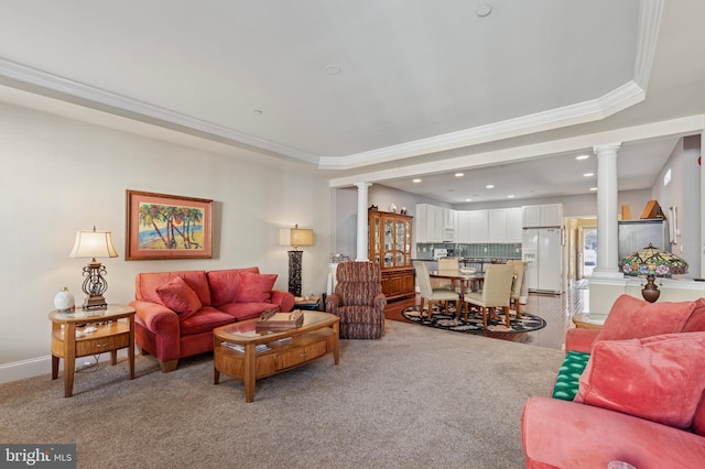 living room featuring ornamental molding, a raised ceiling, and decorative columns