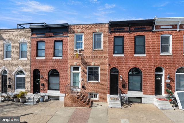 townhome / multi-family property featuring brick siding