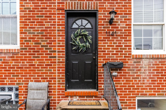 doorway to property with brick siding