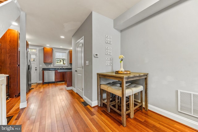 interior space with light wood finished floors, recessed lighting, visible vents, and baseboards