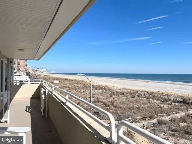 balcony with a water view and a beach view