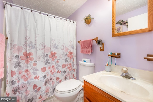 bathroom featuring curtained shower, a textured ceiling, vanity, and toilet