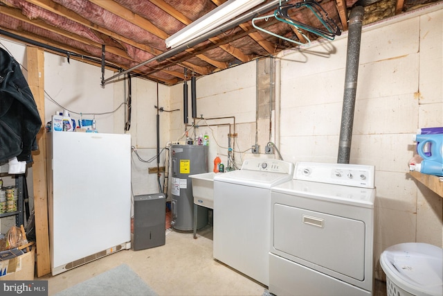 washroom with water heater, laundry area, and separate washer and dryer