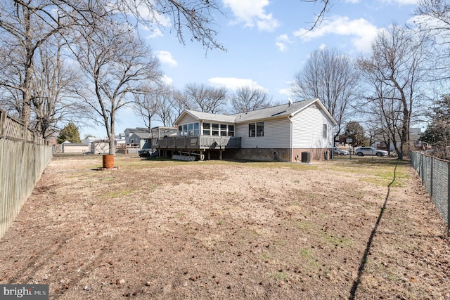 back of house featuring a deck, central AC unit, and a fenced backyard