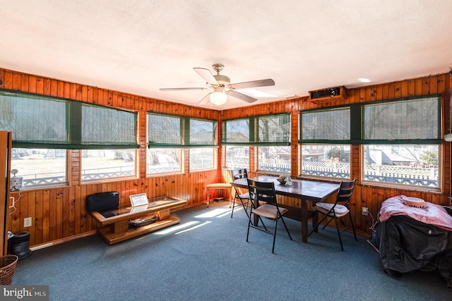 sunroom / solarium featuring a ceiling fan