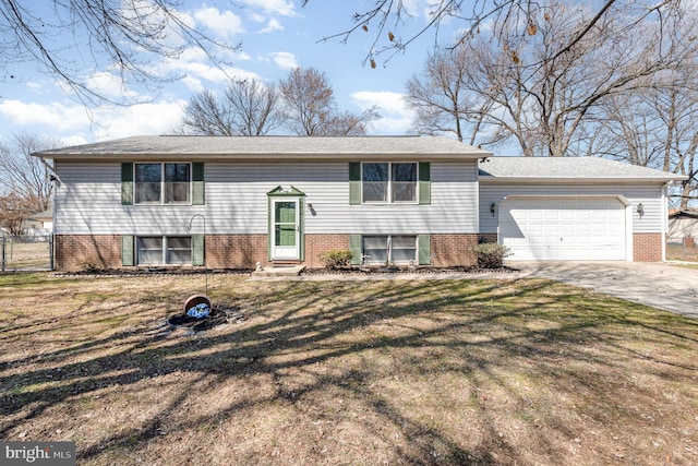 raised ranch with driveway, entry steps, fence, a front yard, and an attached garage