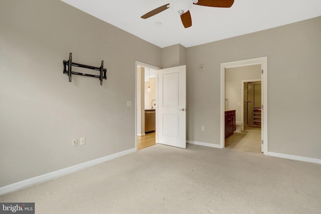 unfurnished bedroom featuring ensuite bath, baseboards, and carpet flooring