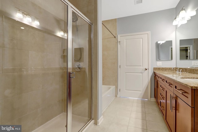 full bathroom featuring tile patterned flooring, a sink, a shower stall, and double vanity