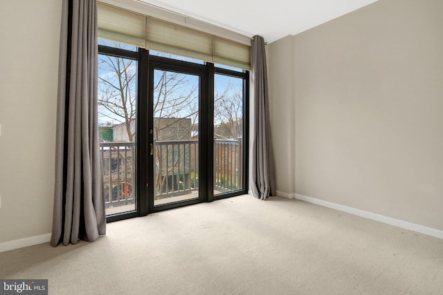 unfurnished room featuring a wall of windows, carpet flooring, and baseboards