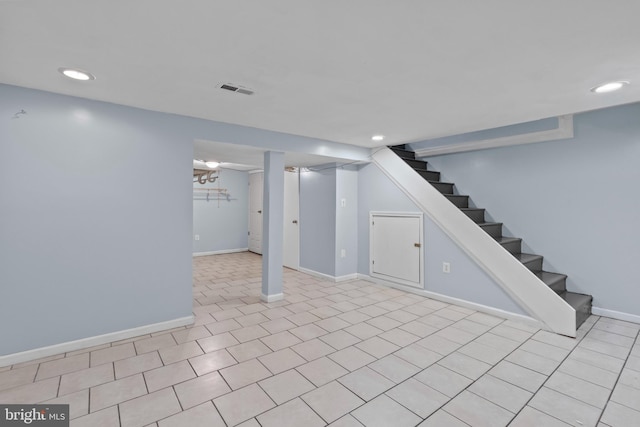 finished below grade area with stairs, recessed lighting, and baseboards