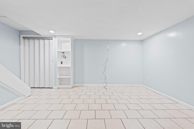 finished basement with baseboards and recessed lighting