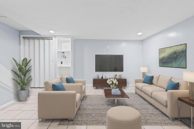 tiled living room with baseboards and recessed lighting