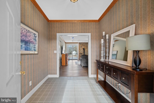 corridor featuring baseboards, ornamental molding, and wallpapered walls