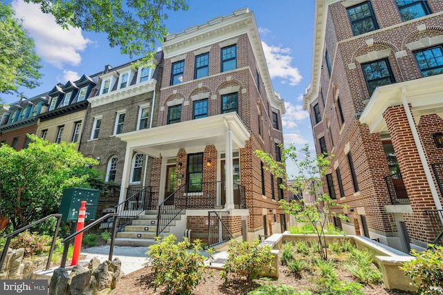 townhome / multi-family property featuring brick siding