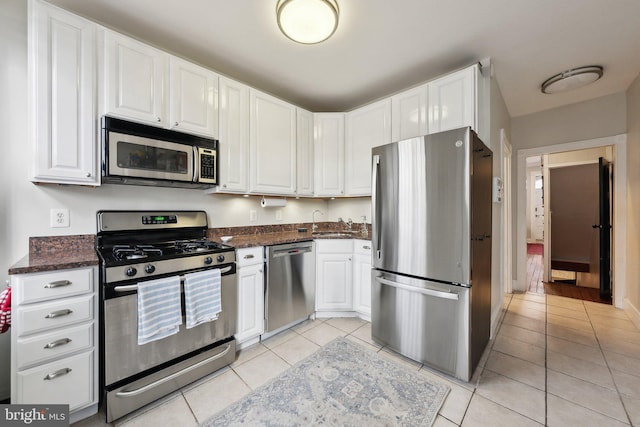 1619 Marion St NW, Washington, DC 20001 - kitchen featuring stainless steel appliances, light tile patterned flooring, and white cabinets
