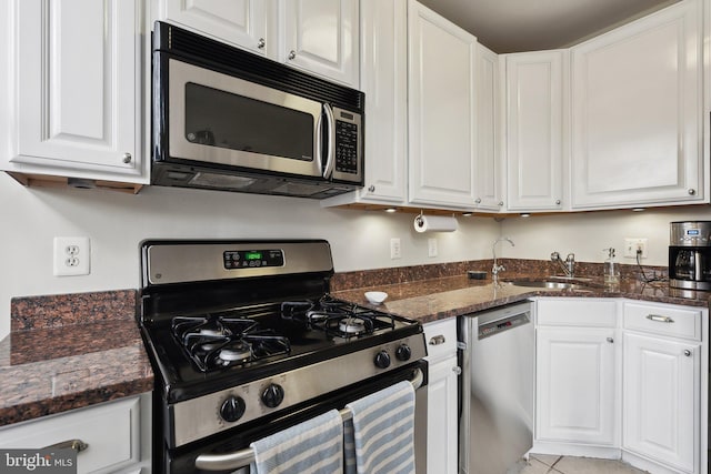 1619 Marion St NW, Washington, DC 20001 - kitchen featuring appliances with stainless steel finishes, a sink, and white cabinets