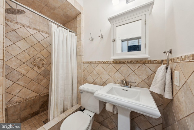 1619 Marion St NW, Washington, DC 20001 - bathroom featuring toilet, tile walls, a stall shower, and a wainscoted wall