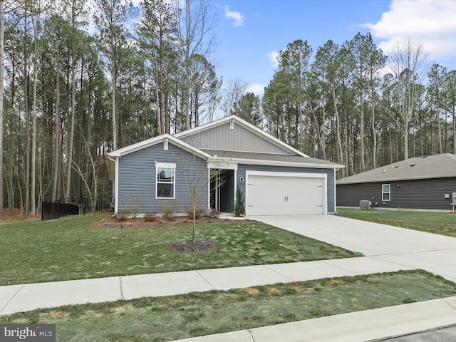 view of front of house with an attached garage, concrete driveway, central AC unit, and a front yard