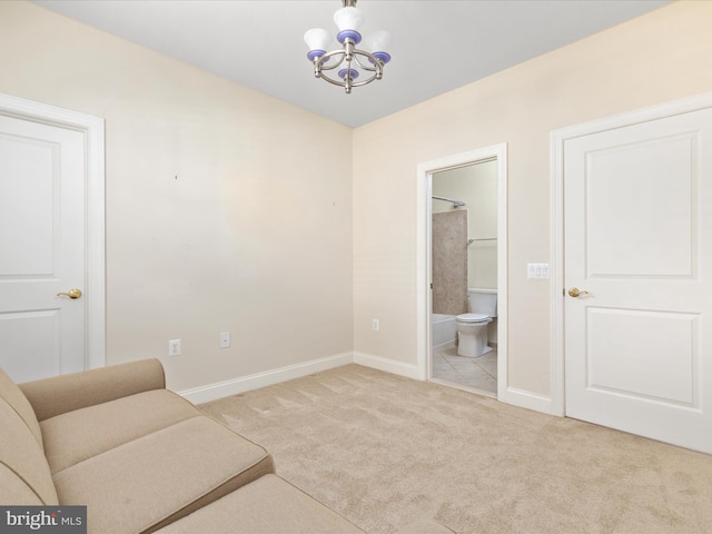 sitting room featuring carpet flooring, a notable chandelier, and baseboards