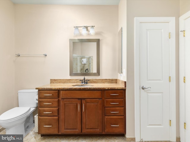 full bathroom featuring toilet, a stall shower, and vanity