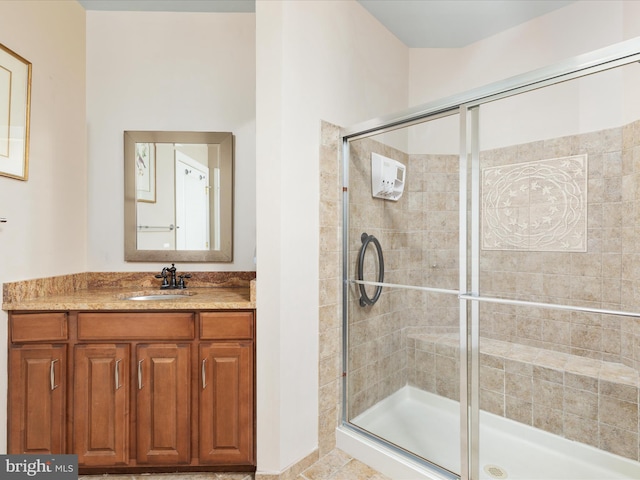 bathroom featuring a shower stall and vanity