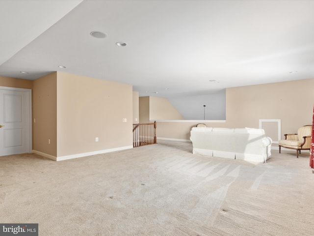 unfurnished living room featuring carpet floors and baseboards