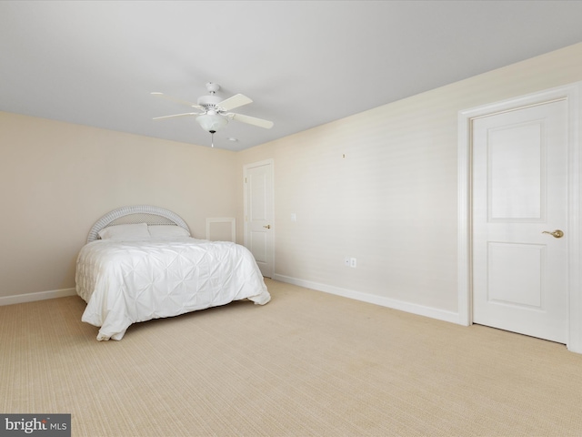 bedroom featuring a ceiling fan, light carpet, and baseboards