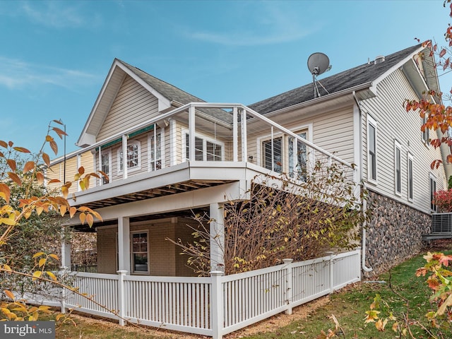 view of property exterior with a porch and brick siding