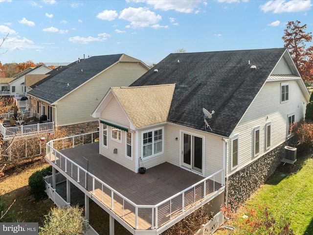 back of property with roof with shingles, a deck, and central air condition unit